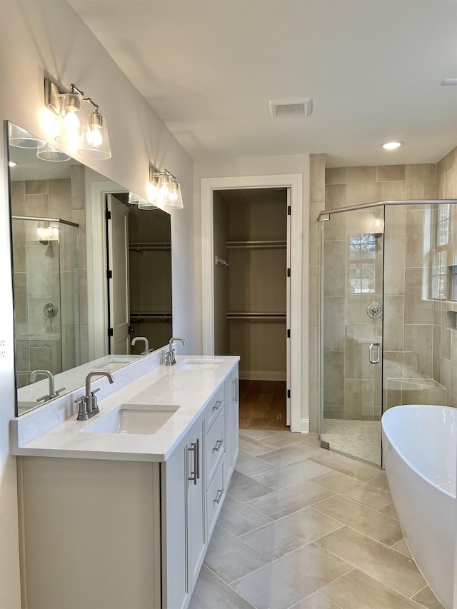 bathroom with tile patterned flooring, vanity, and independent shower and bath