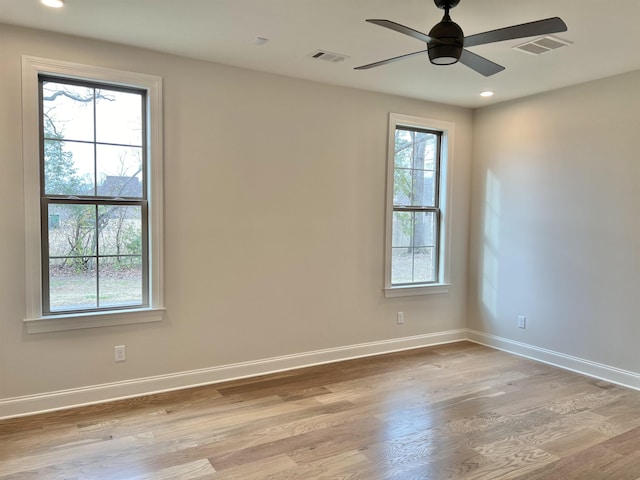 spare room with light hardwood / wood-style flooring, plenty of natural light, and ceiling fan