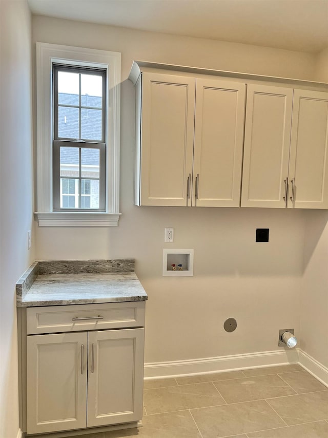 clothes washing area with cabinets, hookup for a washing machine, hookup for an electric dryer, and light tile patterned flooring