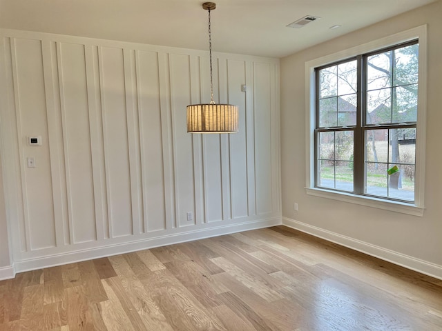 unfurnished dining area featuring light hardwood / wood-style flooring