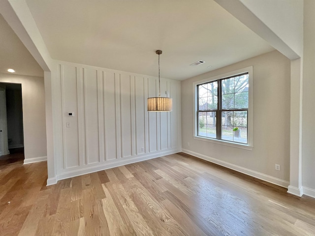 unfurnished dining area with light hardwood / wood-style flooring