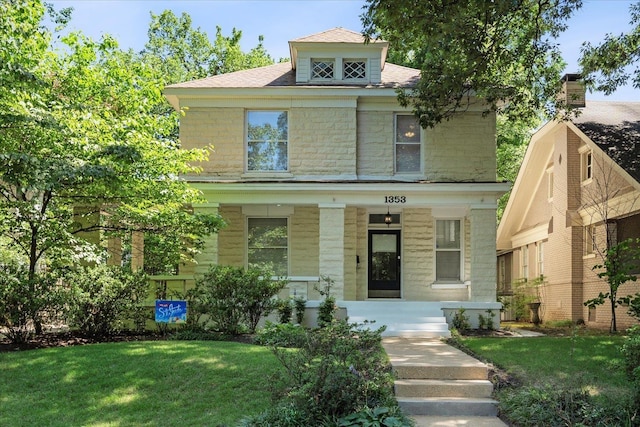 view of front of property with covered porch and a front yard