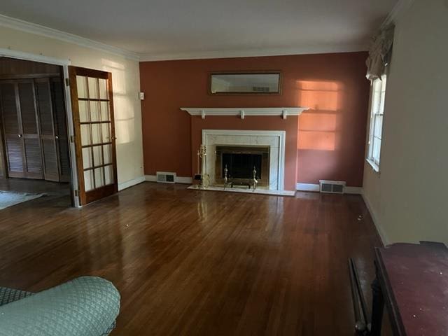 living room featuring dark hardwood / wood-style flooring and ornamental molding