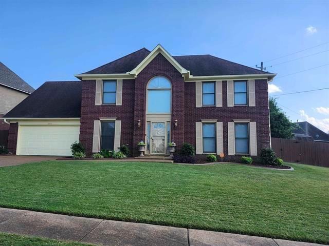 8893 Lindstrom Dr, Memphis, TN 38016 - colonial inspired home featuring a front yard and a garage
