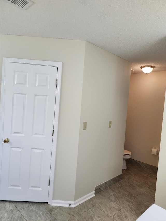 interior space with a textured ceiling