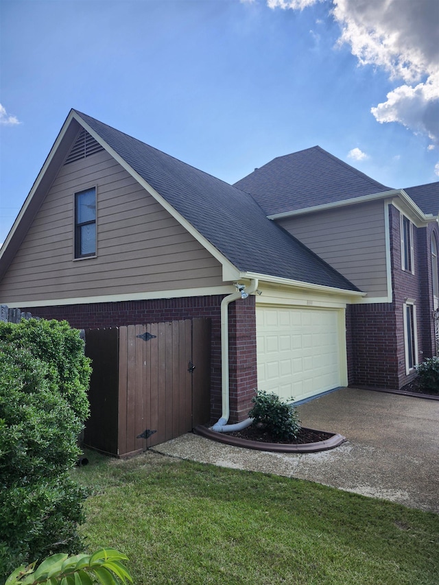 view of front of home with a garage and a front lawn