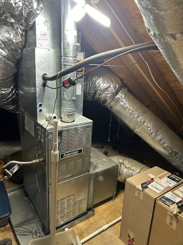 utility room featuring heating unit