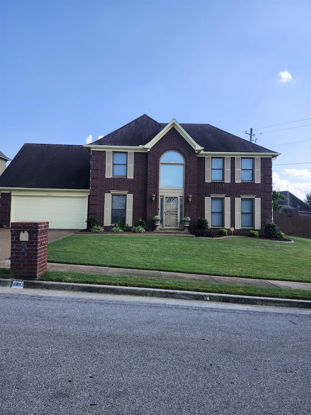 view of front facade with a garage and a front yard