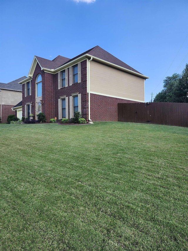 view of side of home with a lawn