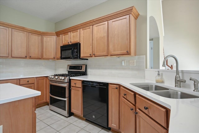 kitchen featuring tasteful backsplash, a textured ceiling, sink, black appliances, and light tile patterned floors