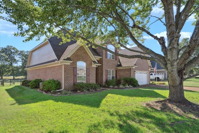 view of front of home featuring a garage and a front lawn