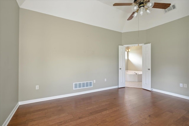 spare room featuring dark hardwood / wood-style floors, ceiling fan, and lofted ceiling