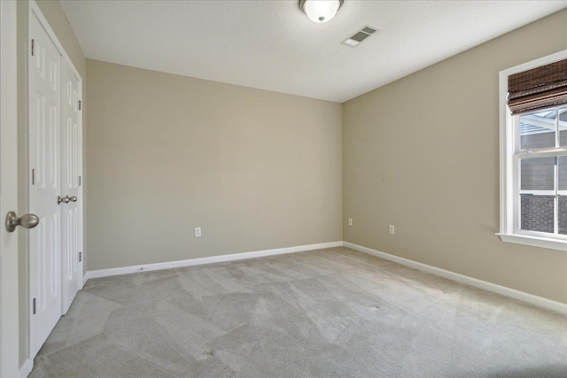 carpeted empty room featuring a wealth of natural light