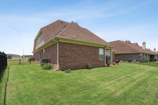 view of side of home with a yard and cooling unit