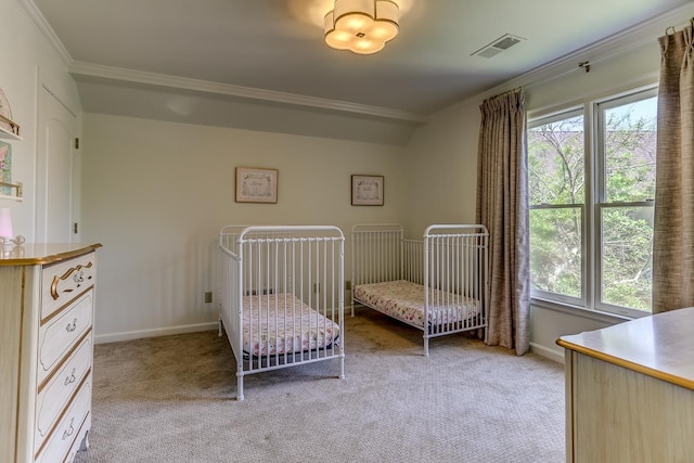 unfurnished bedroom with crown molding, light colored carpet, and a nursery area