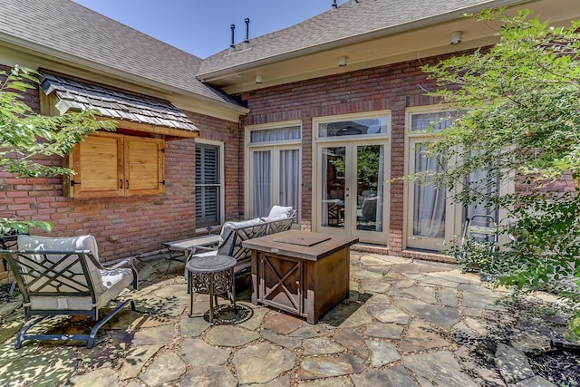 view of patio / terrace featuring french doors and a fire pit