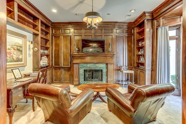 living area featuring built in shelves, wood walls, light colored carpet, and a premium fireplace