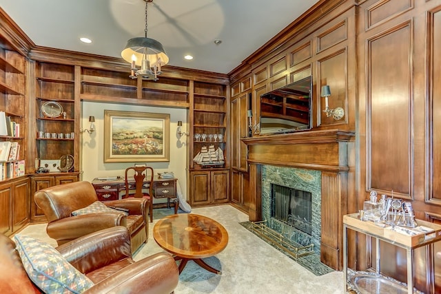 sitting room with light carpet, built in features, ornamental molding, and a premium fireplace