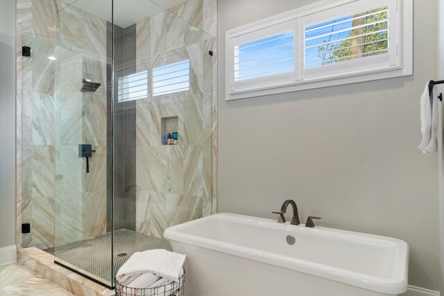 bathroom featuring separate shower and tub