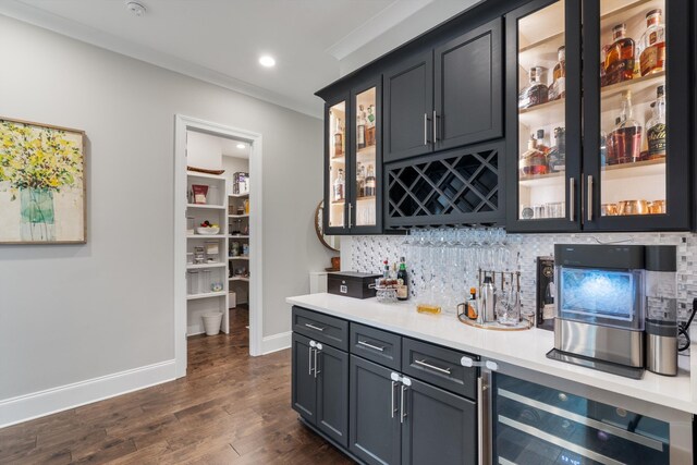 bar with wine cooler, decorative backsplash, dark wood-type flooring, and ornamental molding