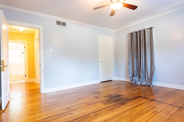 spare room with hardwood / wood-style flooring, ceiling fan, and crown molding