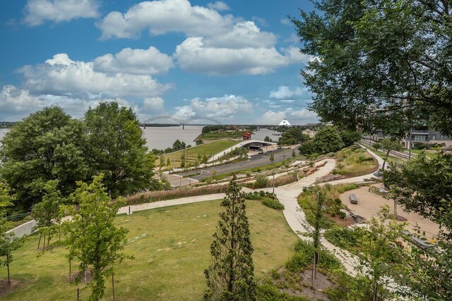 view of property's community featuring a yard and a water view