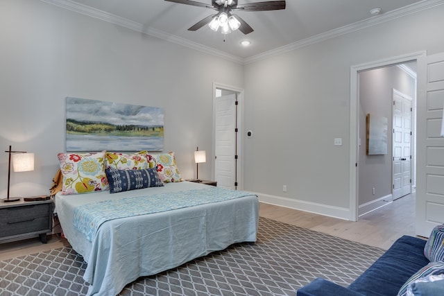 bedroom featuring hardwood / wood-style flooring, ceiling fan, and ornamental molding