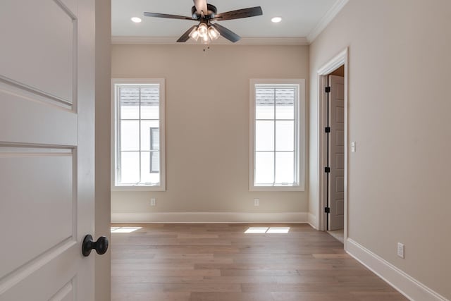 unfurnished room featuring plenty of natural light, ornamental molding, and light hardwood / wood-style flooring