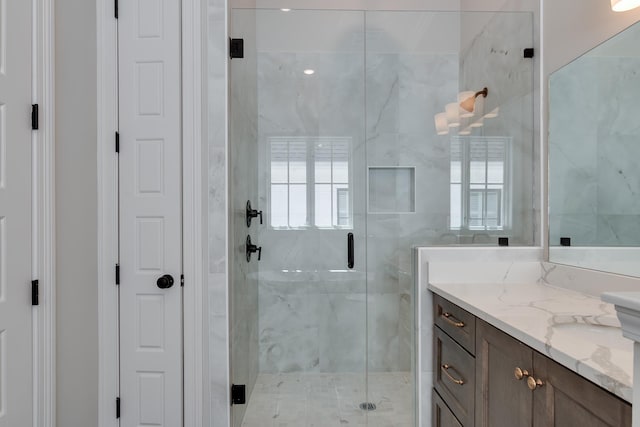 bathroom with vanity and a shower with shower door