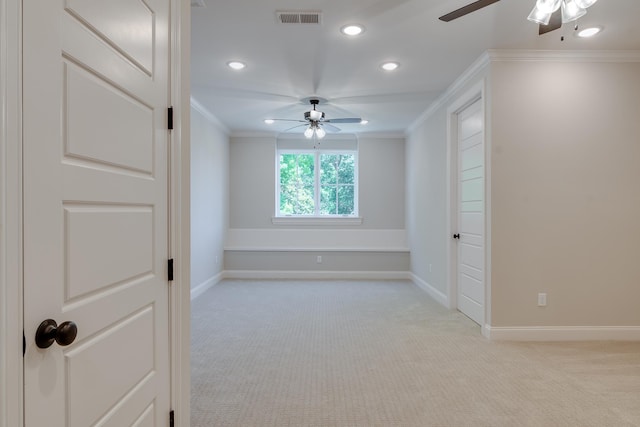 carpeted empty room featuring ceiling fan and ornamental molding