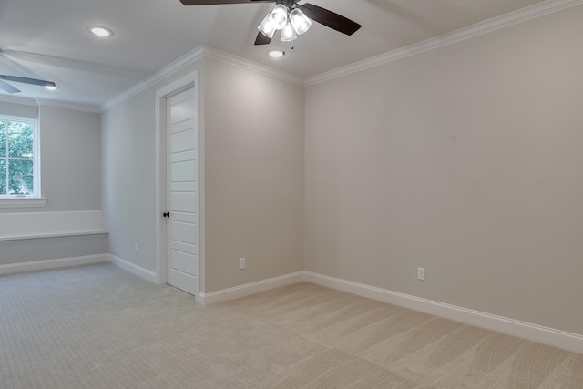 carpeted spare room featuring ceiling fan and ornamental molding