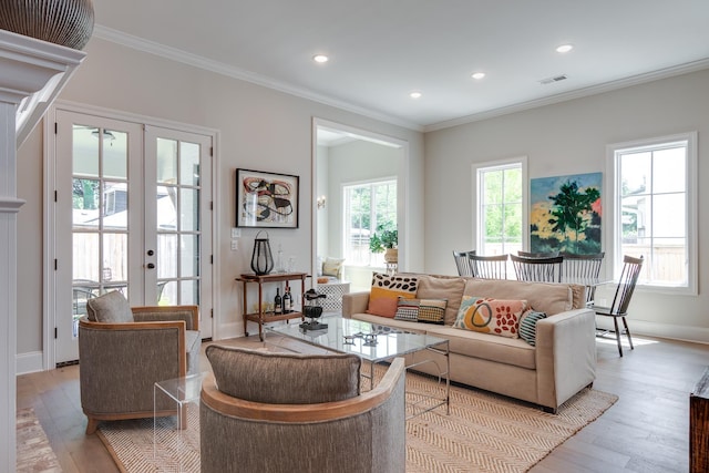 living room with crown molding, french doors, and light wood-type flooring