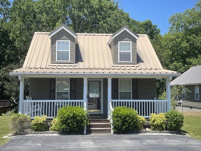 view of front of property featuring covered porch and metal roof