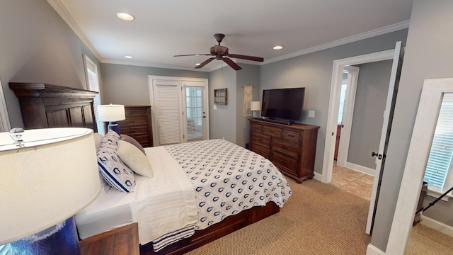 carpeted bedroom with ornamental molding, a closet, and ceiling fan