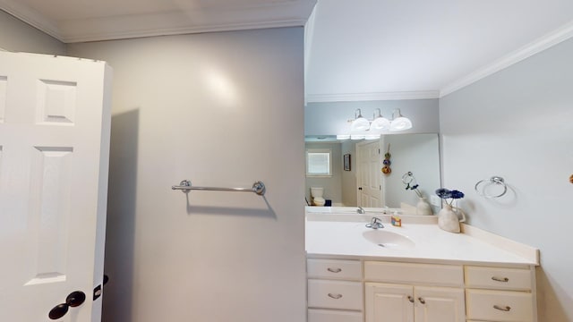 bathroom with ornamental molding, vanity, and toilet