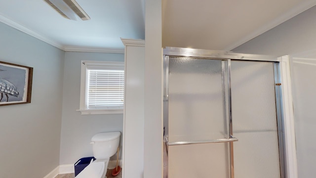 bathroom with walk in shower, ornamental molding, and toilet