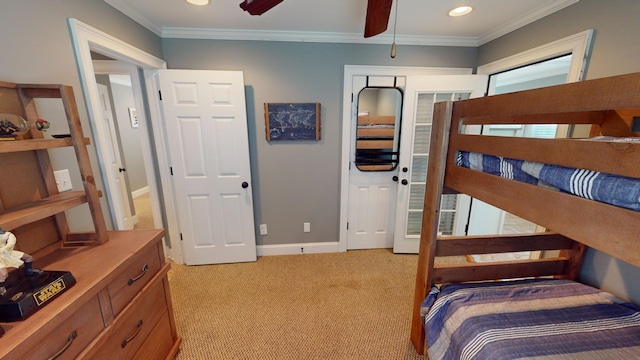 bedroom with ornamental molding, ceiling fan, and light colored carpet