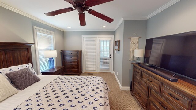 carpeted bedroom with ornamental molding and ceiling fan