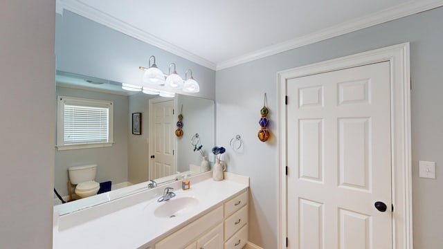 bathroom with vanity, toilet, and crown molding