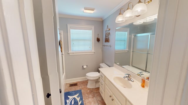 bathroom featuring tile floors, crown molding, toilet, and vanity with extensive cabinet space