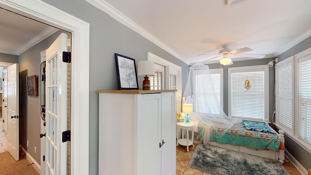 tiled bedroom with crown molding and ceiling fan