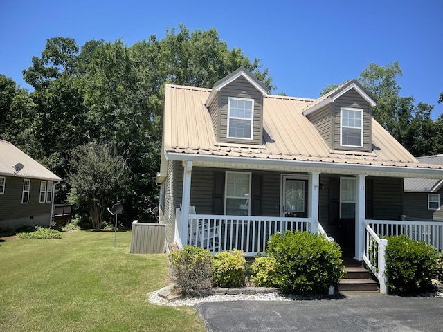 cape cod house featuring a front lawn and a porch