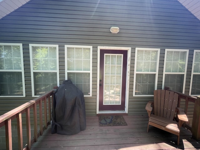 wooden deck featuring a grill