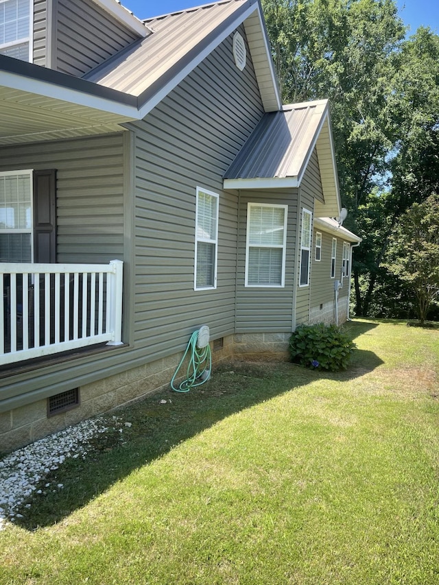 view of home's exterior featuring metal roof, a yard, and crawl space