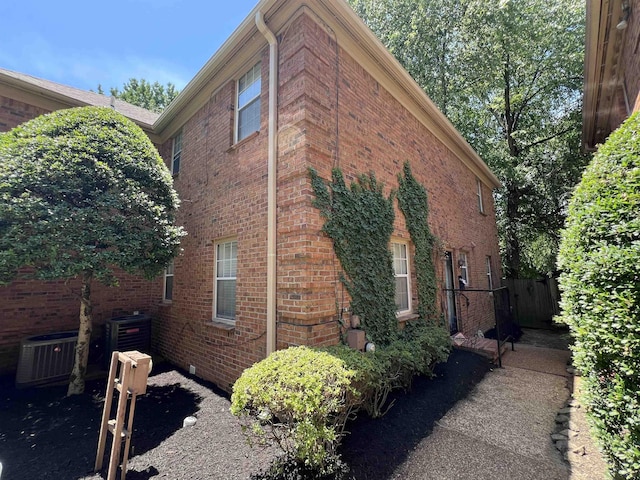 view of side of home with central AC unit