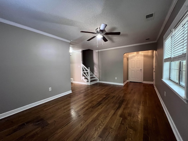 unfurnished living room featuring a textured ceiling, crown molding, ceiling fan, and dark wood-type flooring