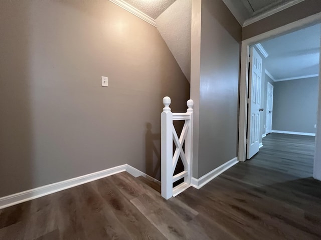 stairway with hardwood / wood-style floors, a textured ceiling, and crown molding