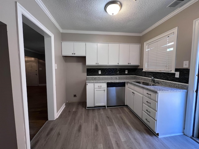 kitchen with white cabinets, dishwasher, sink, and tasteful backsplash