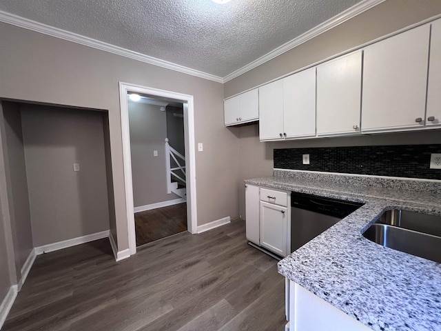 kitchen with white cabinetry, sink, light stone counters, a textured ceiling, and decorative backsplash