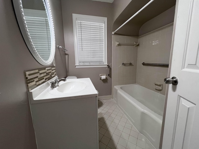 bathroom with tile patterned floors, vanity, decorative backsplash, and tiled shower / bath